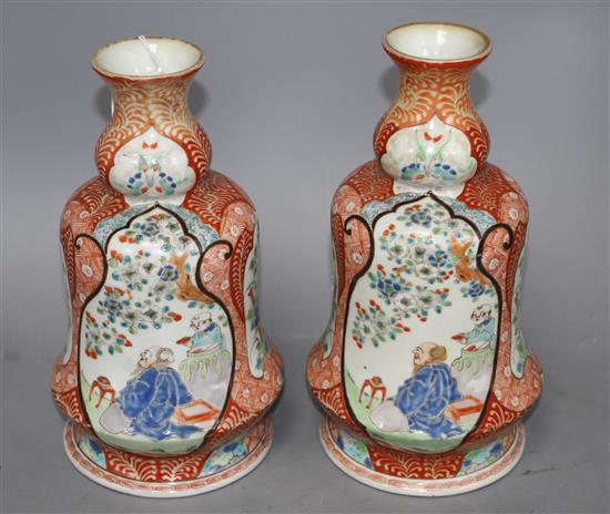 A pair of Japanese enamelled porcelain huqqa base vases, decorated with figures, height 25cm